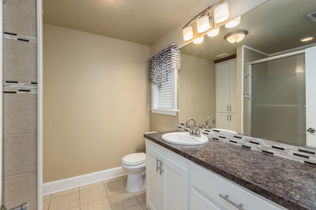 bathroom featuring tile patterned floors, a shower with door, vanity, and toilet