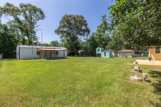 view of yard featuring a wooden deck and an outdoor structure