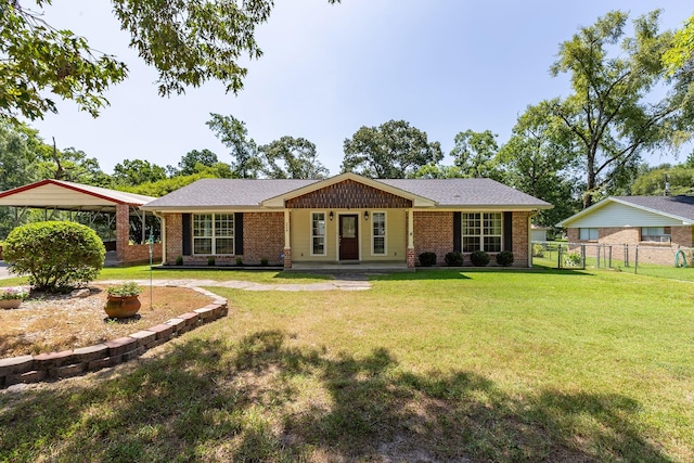 view of front facade with covered porch, a carport, and a front lawn