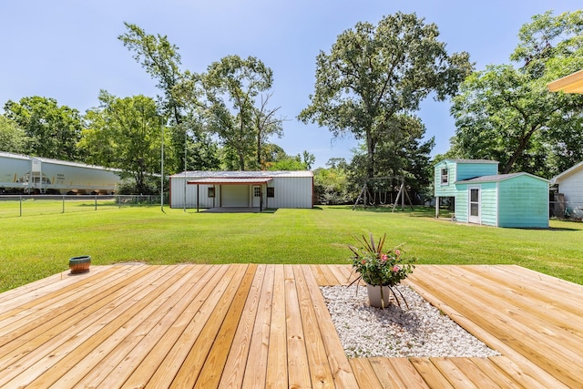 deck featuring an outbuilding and a yard