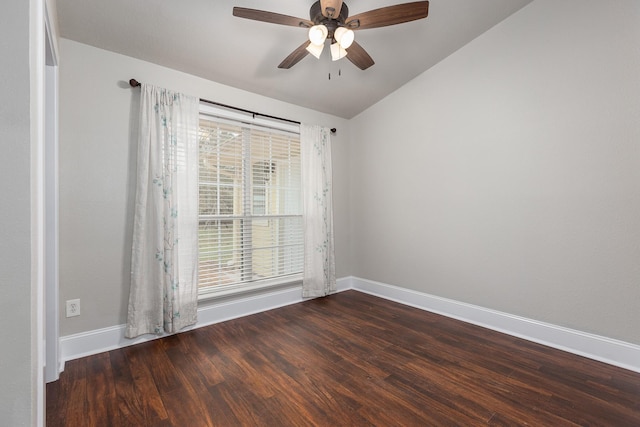 empty room with dark hardwood / wood-style flooring, plenty of natural light, and vaulted ceiling