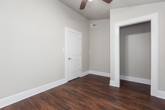 unfurnished bedroom featuring dark hardwood / wood-style flooring, ceiling fan, and lofted ceiling