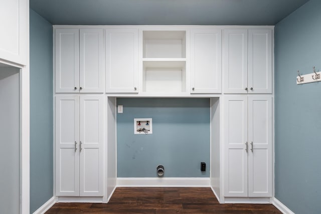 laundry area featuring cabinets, washer hookup, and dark hardwood / wood-style flooring