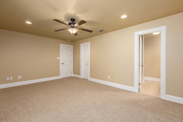 unfurnished bedroom with ceiling fan and light carpet