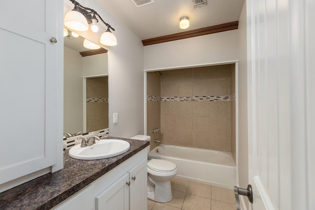 full bathroom with vanity, tile patterned floors, tiled shower / bath, toilet, and a textured ceiling