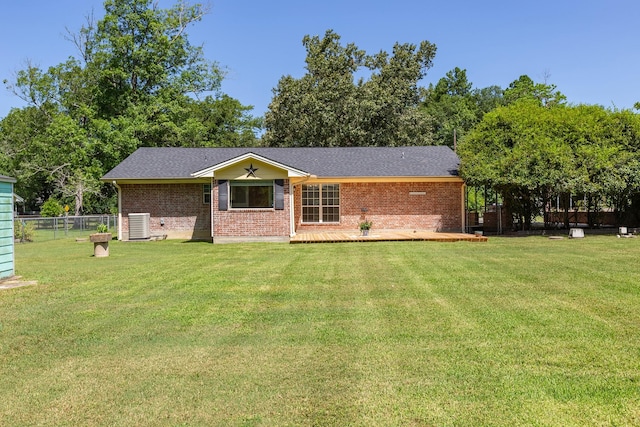 view of front of home featuring central AC, a wooden deck, and a front lawn