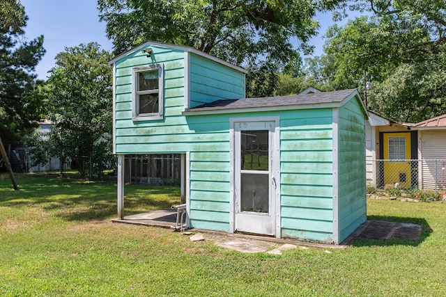 view of outbuilding featuring a yard