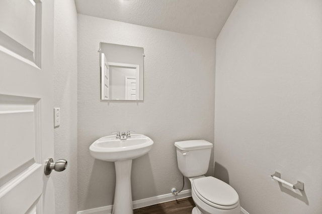 bathroom featuring hardwood / wood-style floors, toilet, and sink