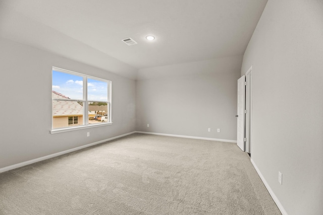 unfurnished room featuring light carpet