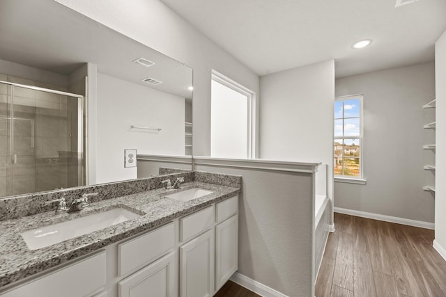 bathroom featuring shower with separate bathtub, vanity, and hardwood / wood-style floors