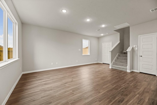 unfurnished living room featuring dark hardwood / wood-style floors