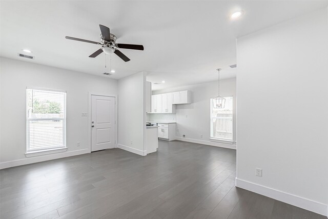 8211 Gladstone St, Houston, TX 77051 - unfurnished living room with a ceiling fan, dark wood-style flooring, recessed lighting, and a chandelier