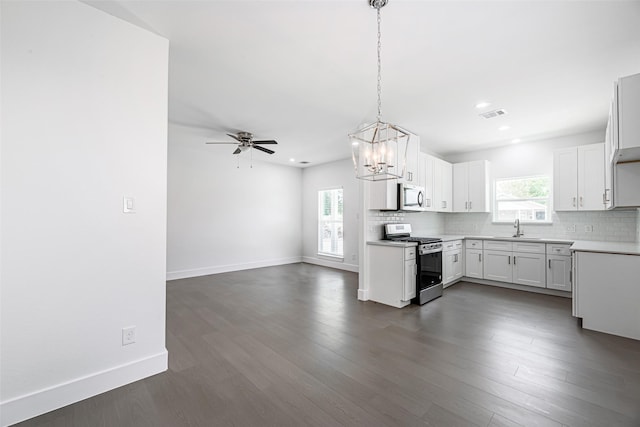 8211 Gladstone St, Houston, TX 77051 - kitchen with appliances with stainless steel finishes, a chandelier, open floor plan, backsplash, and dark wood-style floors