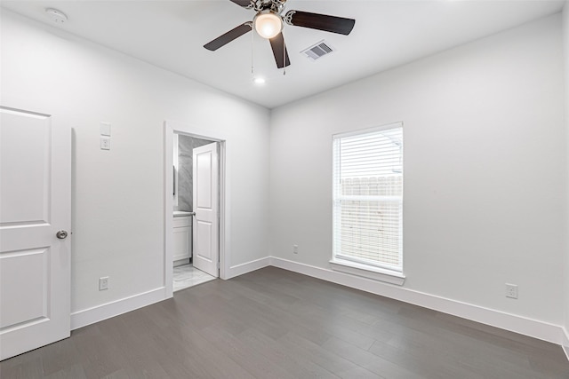 unfurnished bedroom with hardwood / wood-style flooring, ensuite bath, and ceiling fan