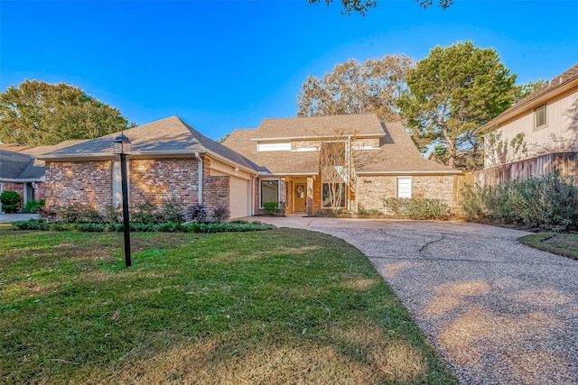 view of front of property with a garage and a front lawn