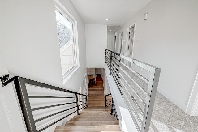 stairs featuring hardwood / wood-style flooring