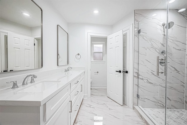 bathroom featuring vanity, toilet, and a shower with shower door