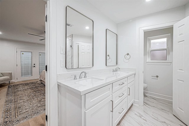 bathroom featuring french doors, vanity, toilet, and ceiling fan