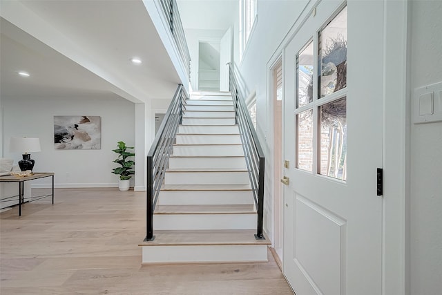 stairs featuring hardwood / wood-style floors