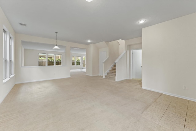 unfurnished living room featuring light colored carpet