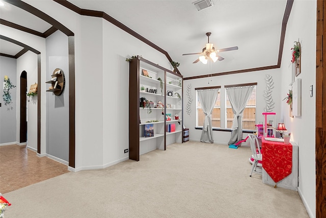 rec room featuring ornamental molding, light colored carpet, ceiling fan, and lofted ceiling