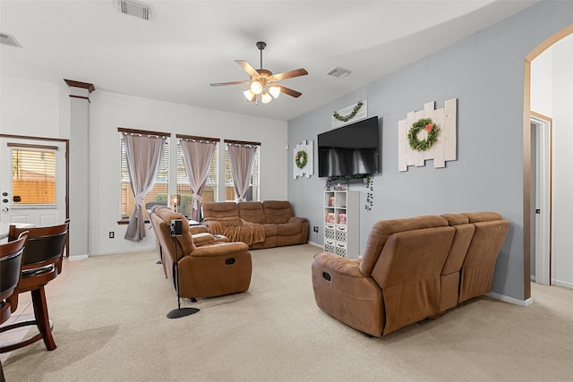 living room featuring carpet flooring and ceiling fan