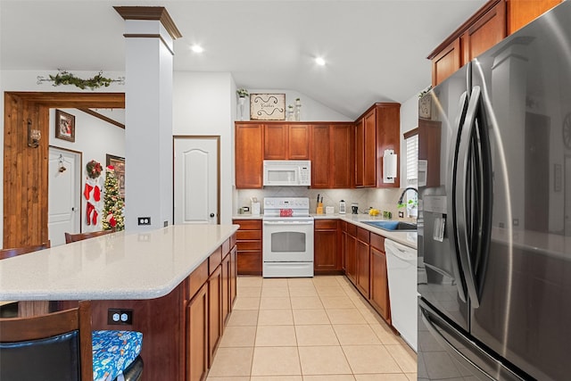 kitchen featuring tasteful backsplash, white appliances, sink, lofted ceiling, and light tile patterned flooring