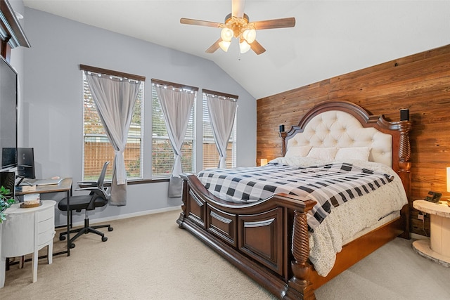 carpeted bedroom featuring ceiling fan, wood walls, and vaulted ceiling