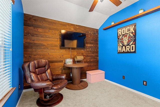 living area featuring carpet, ceiling fan, and vaulted ceiling