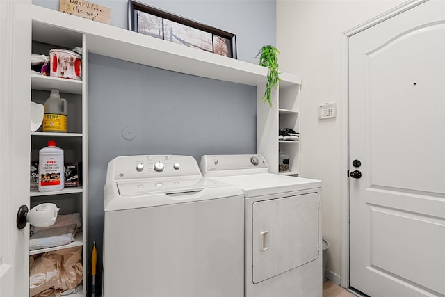 clothes washing area featuring washer and clothes dryer