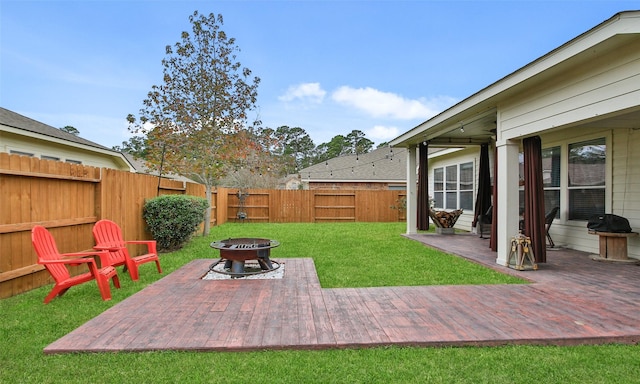 view of yard with a patio and an outdoor fire pit