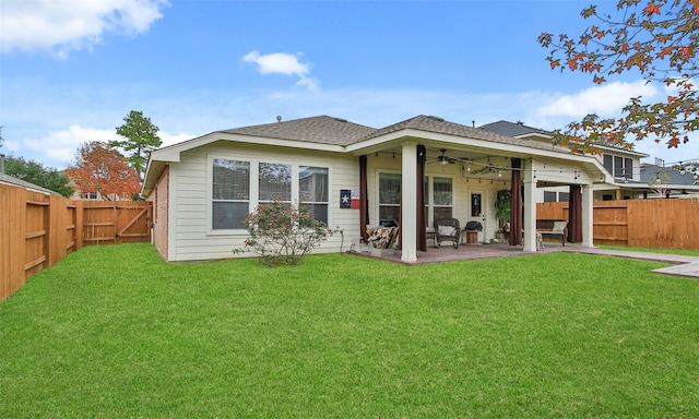 back of house featuring a lawn, ceiling fan, and a patio