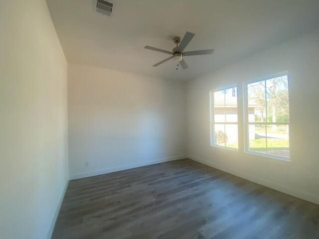 spare room with dark hardwood / wood-style floors and ceiling fan