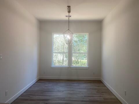 unfurnished dining area with dark hardwood / wood-style floors