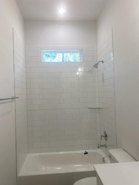 full bathroom featuring toilet, vanity, and tiled shower / bath