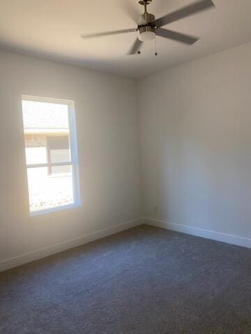 unfurnished room with ceiling fan and dark carpet