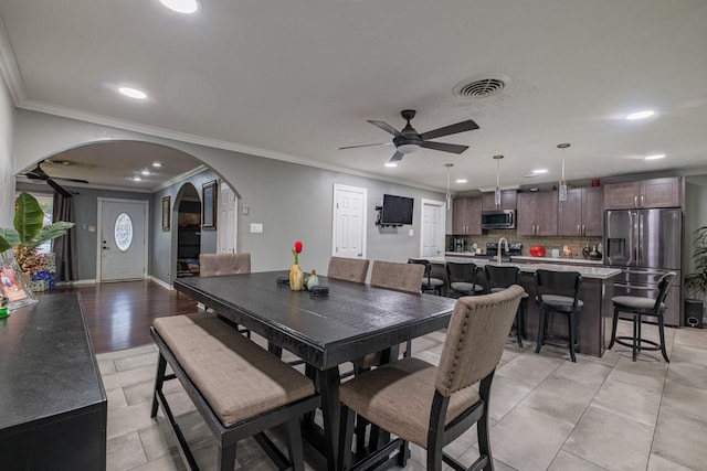 2007 Flynn Dr, Pasadena, TX 77502 - dining area featuring arched walkways, a ceiling fan, recessed lighting, and ornamental molding