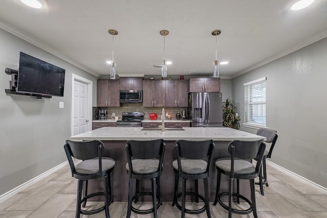 kitchen featuring pendant lighting, stainless steel appliances, tasteful backsplash, and sink