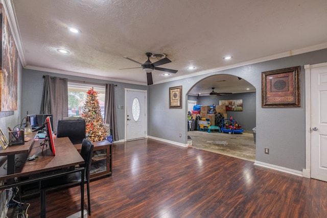 office space featuring a textured ceiling, dark wood-type flooring, ceiling fan, and ornamental molding