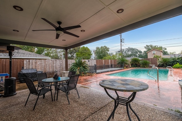 view of swimming pool featuring a patio and ceiling fan