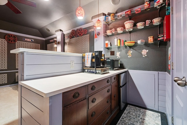 kitchen with pendant lighting, vaulted ceiling, ceiling fan, and stainless steel refrigerator