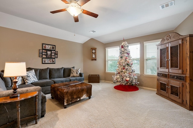 living room with ceiling fan, lofted ceiling, and light carpet