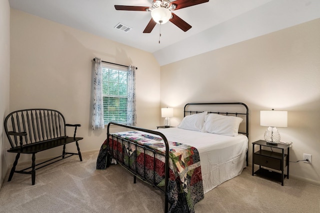 carpeted bedroom with vaulted ceiling and ceiling fan