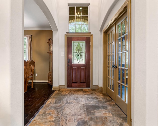 entrance foyer with crown molding, french doors, and dark hardwood / wood-style floors