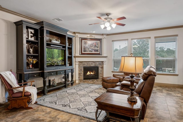 living room with ceiling fan, ornamental molding, and a fireplace