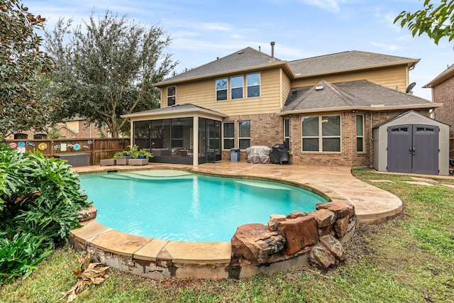 view of swimming pool with a sunroom and a shed