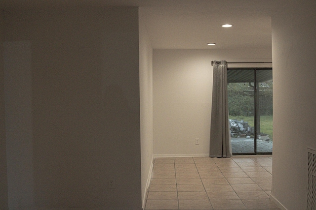 hall featuring light tile patterned flooring