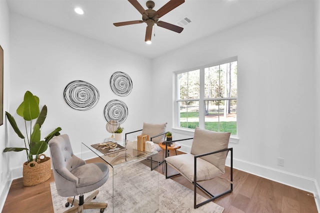 sitting room featuring wood-type flooring and ceiling fan