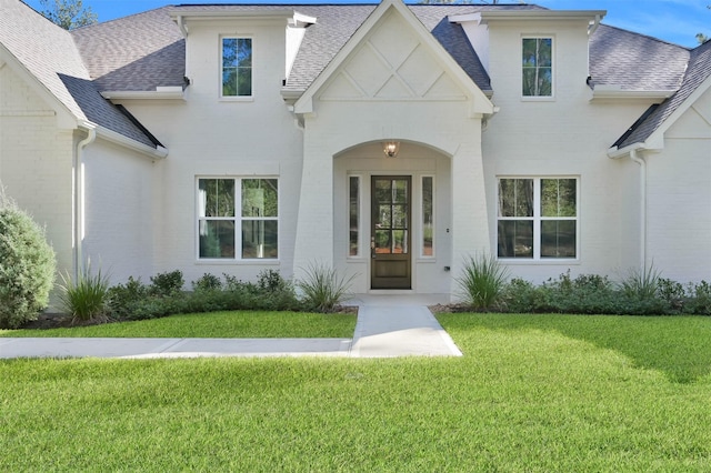 property entrance featuring a lawn