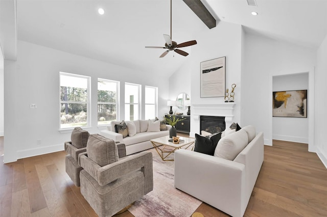 living room with ceiling fan, high vaulted ceiling, and light hardwood / wood-style floors